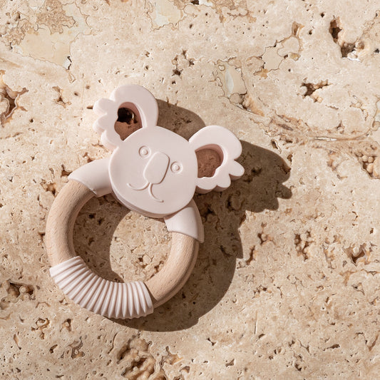 Mini and Boo koala-themed teether in food-grade silicone and beechwood – gentle texture for gum relief, natural antibacterial wood, BPA-free and safe for self-soothing babies.